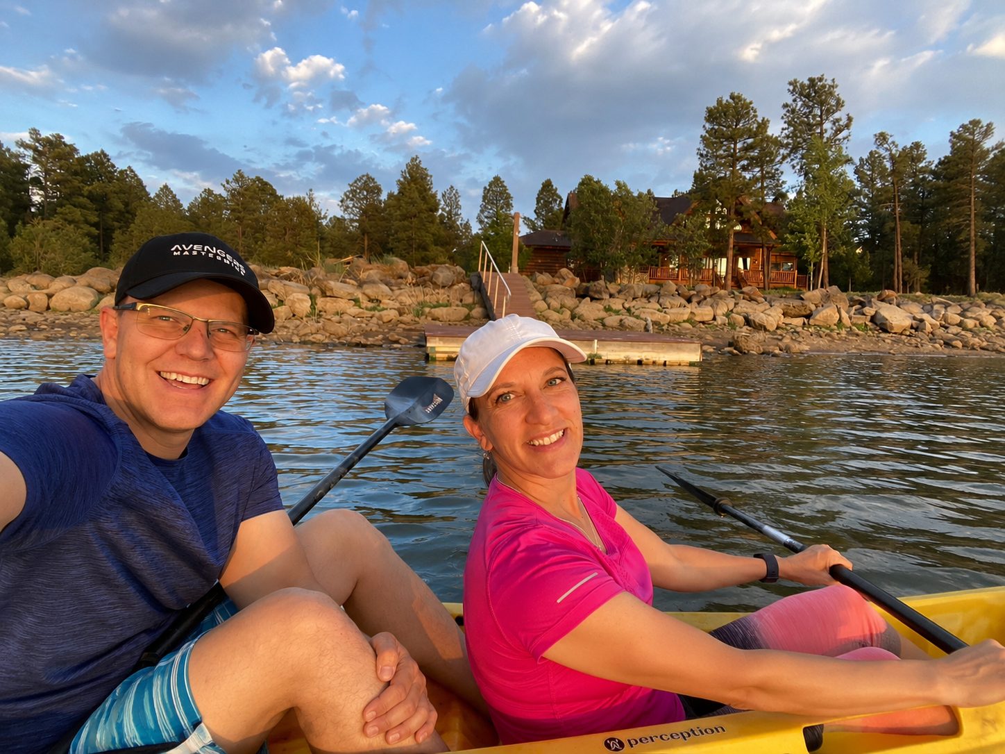 A couple kayaking together on calm Rainbow Lake in Lakeside, Arizona