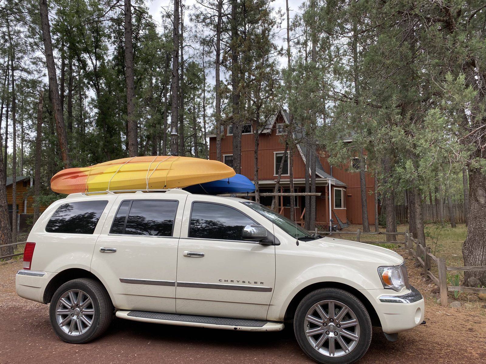 Kayaks strapped to a car roof outside a cabin near Rainbow Lake, Lakeside, Arizona