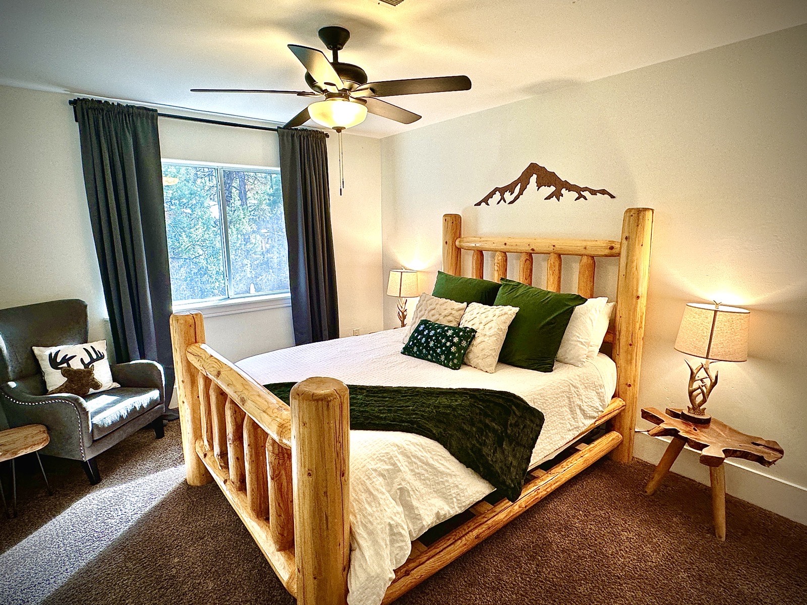 Parkway Lodge king bedroom with log bed frame and mountain wall art