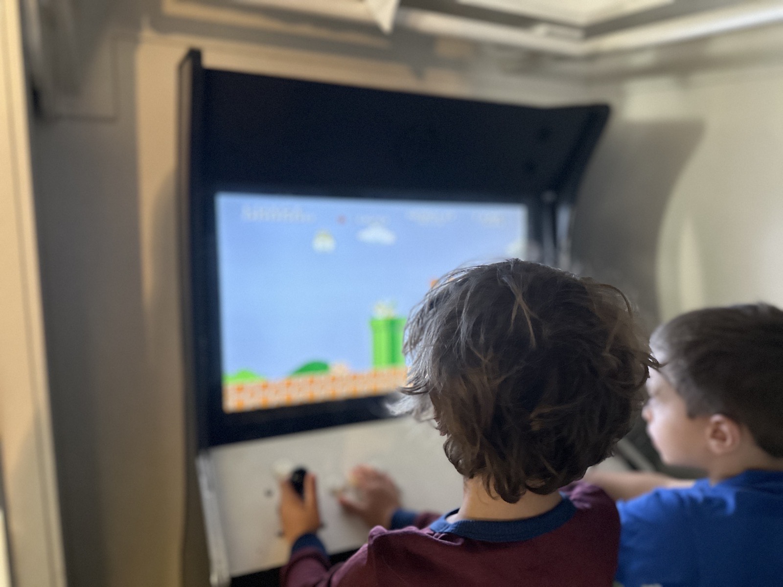 Kids playing video games on the big screen at Parkway Lodge